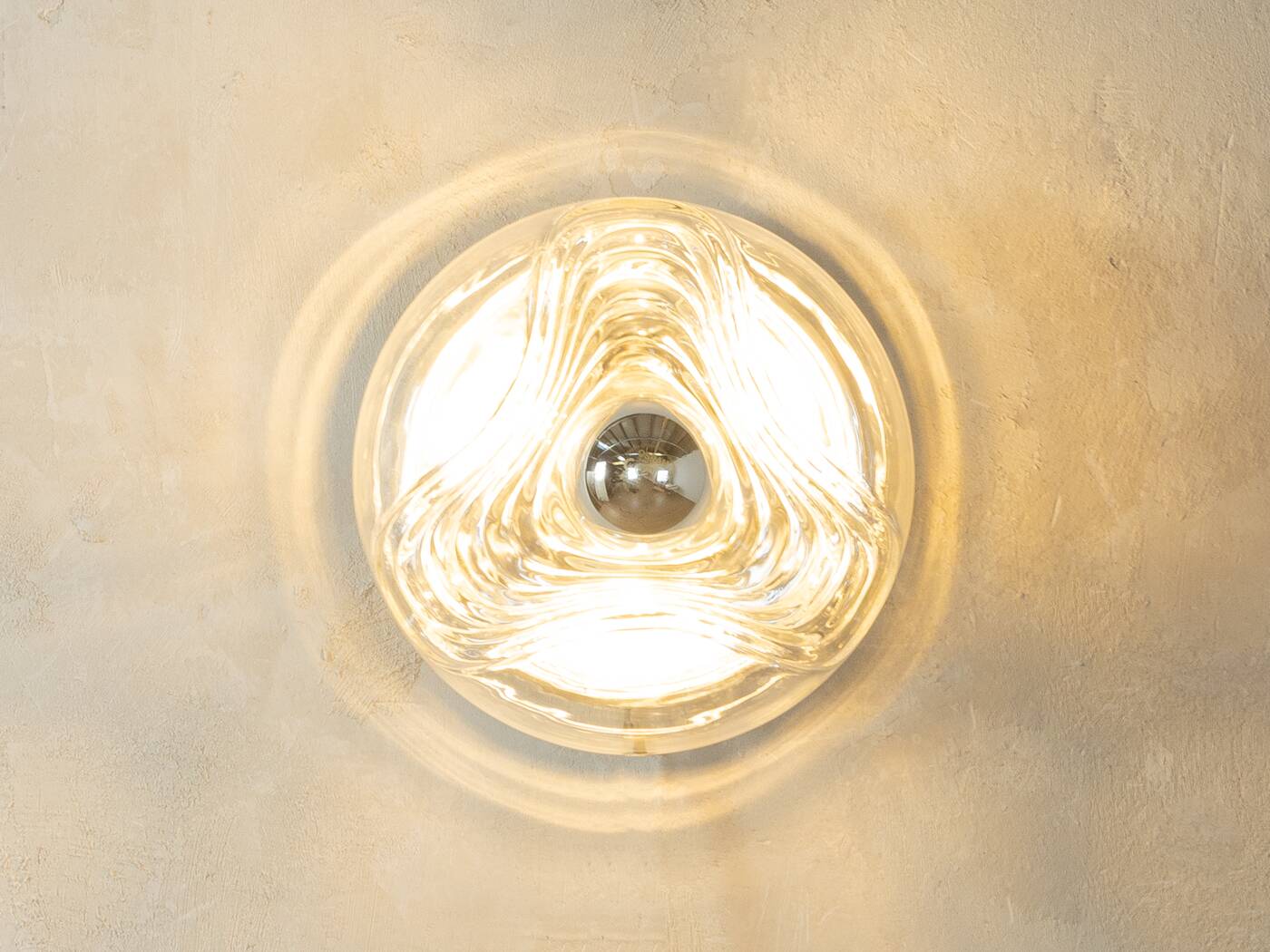 Sculptural wave wall lamp made of structured solid glass by peill & putzler