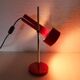 Red metal articulated desk lamp