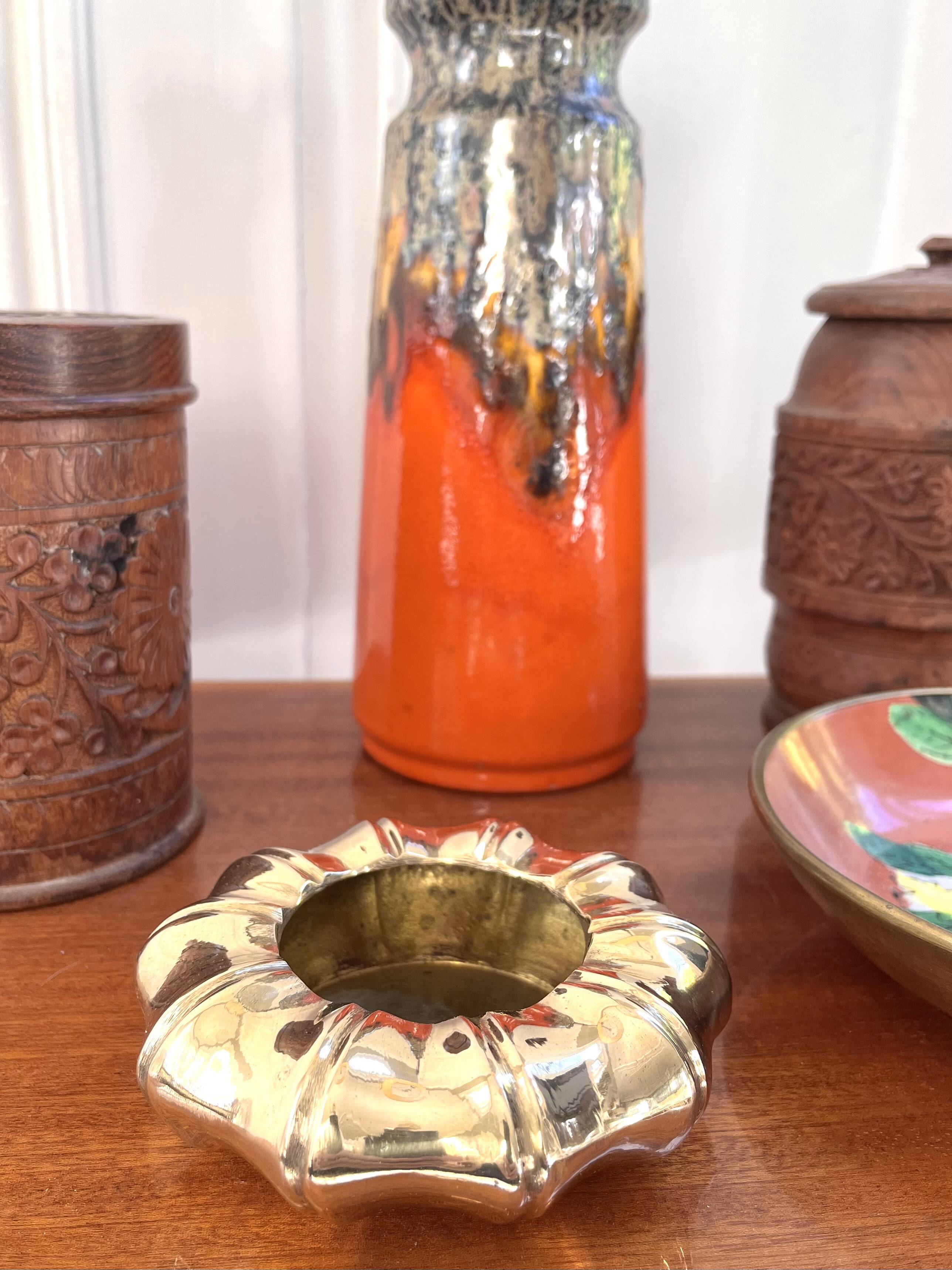 Golden brass ashtray with bamboo decoration.