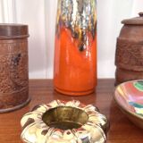 Golden brass ashtray with bamboo decoration.