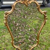 Louis XV Style wood and gilded stucco mirror with animated shape