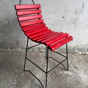Red slatted chair with a black metal frame.