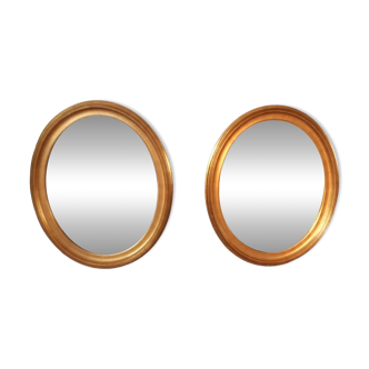 Pair of golden oval mirrors