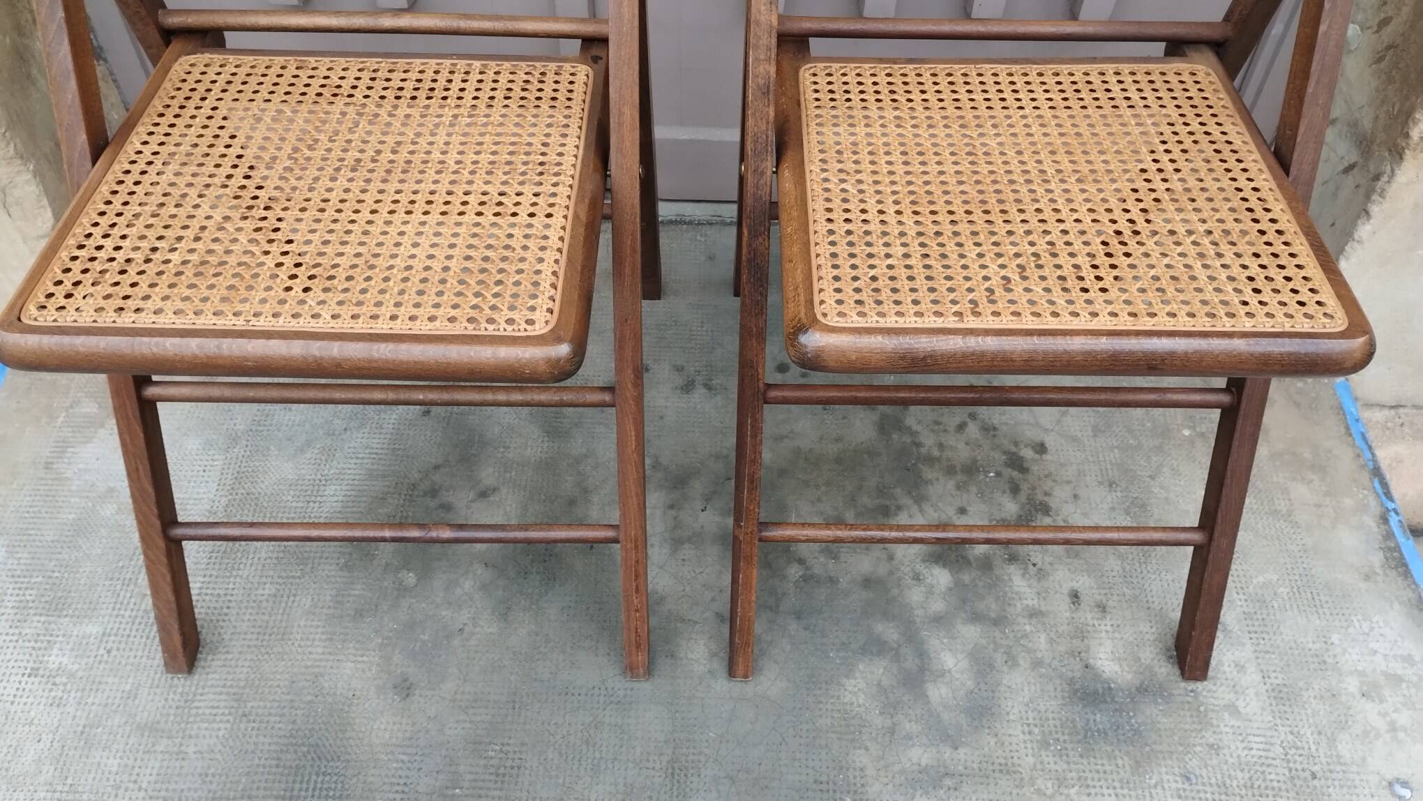 Pair of vintage wooden and cane folding chairs