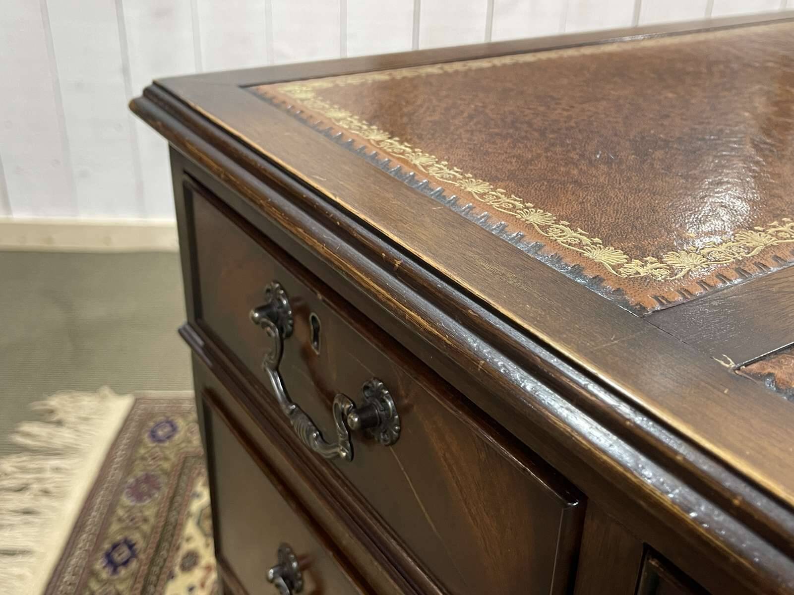 English mahogany pedestal desk with leather top from the 1950s