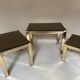 Set of three nesting side tables in brass and smoked mirror.