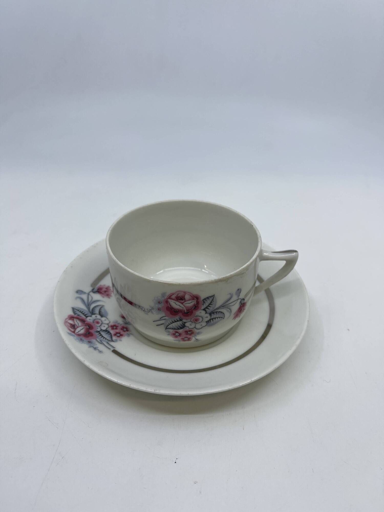 Porcelain coffee service with floral decoration and silver trim.