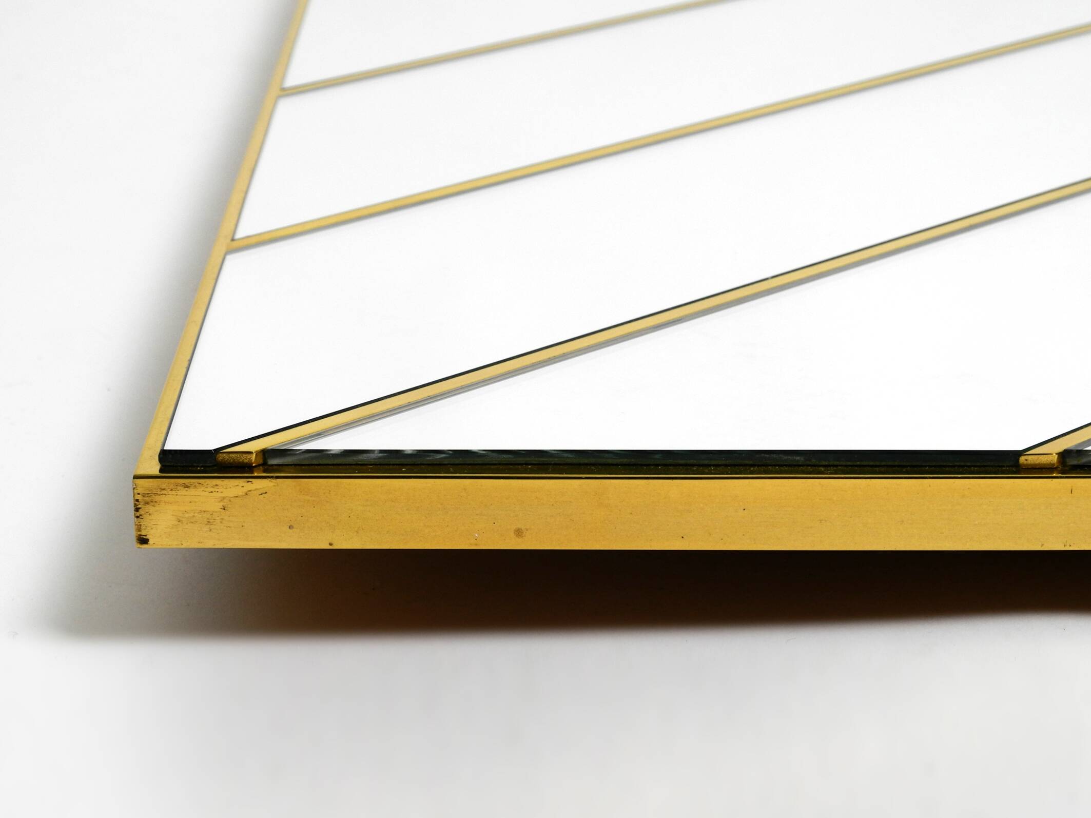 Large, exceptional 1970s brass wall mirror with diagonal mirror strips