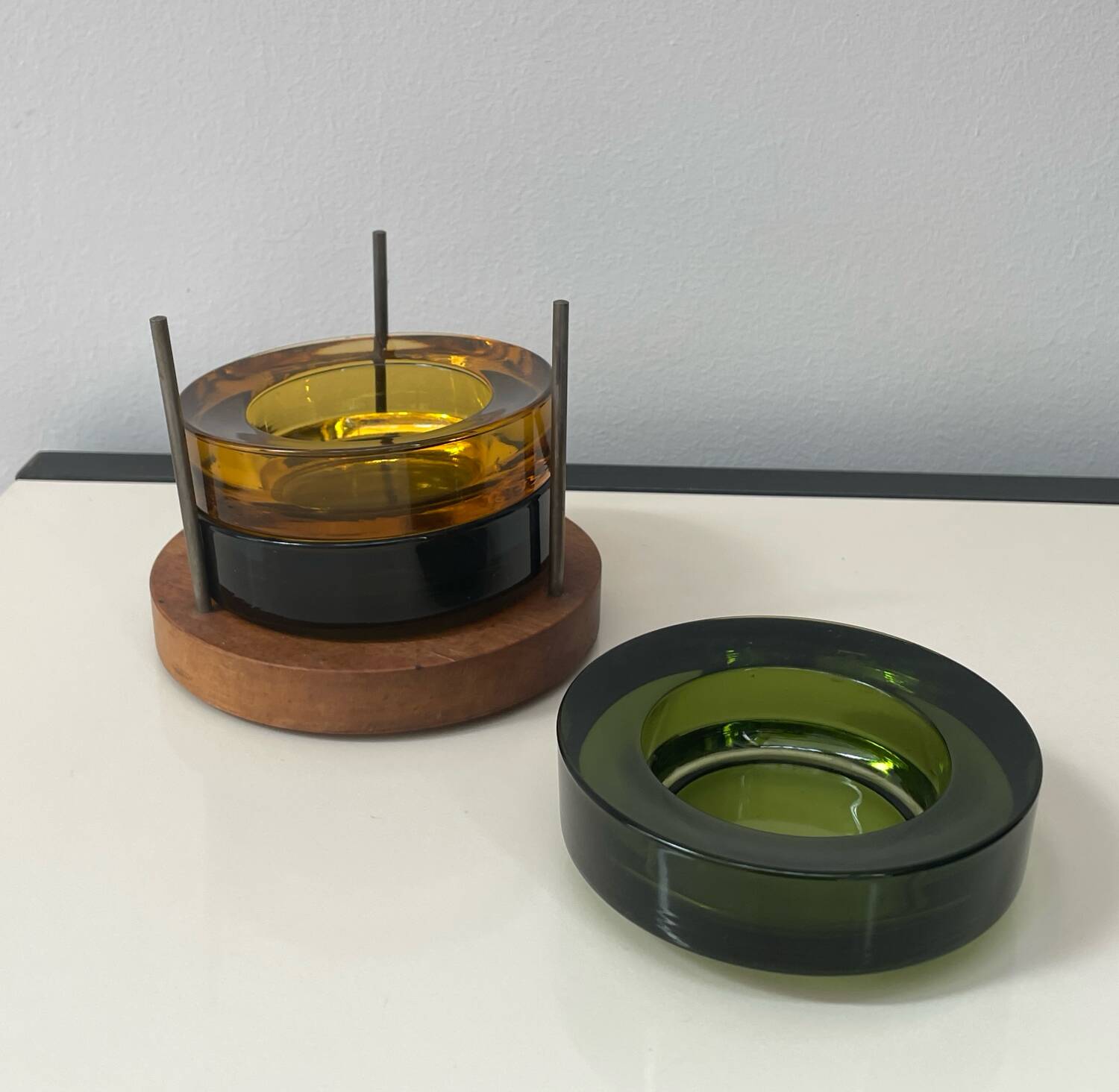 Set of 3 stackable glass catchalls with a teak base.