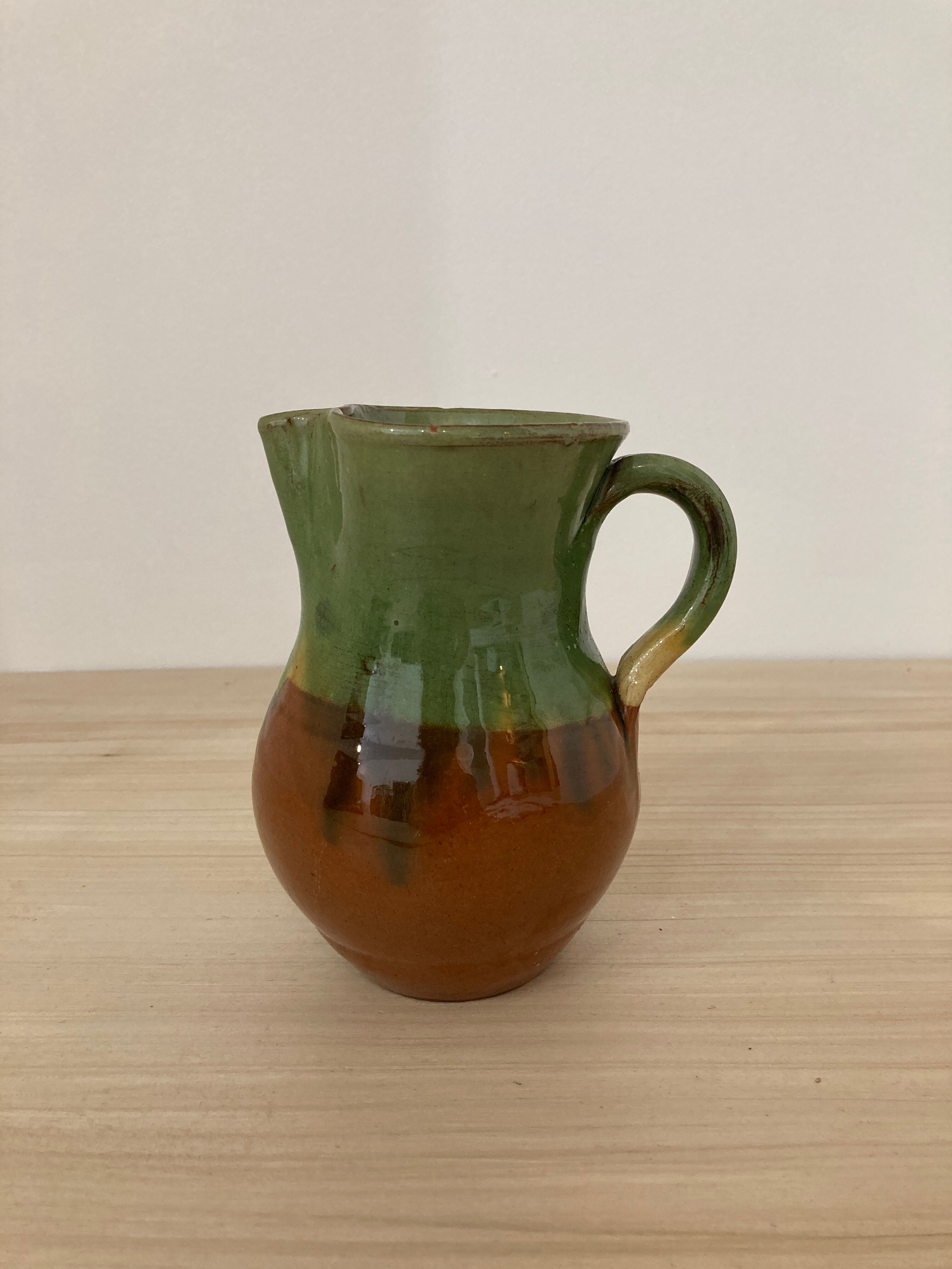 Green and brown ceramic pitcher