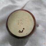 Brown ceramic teapot and milk jugs