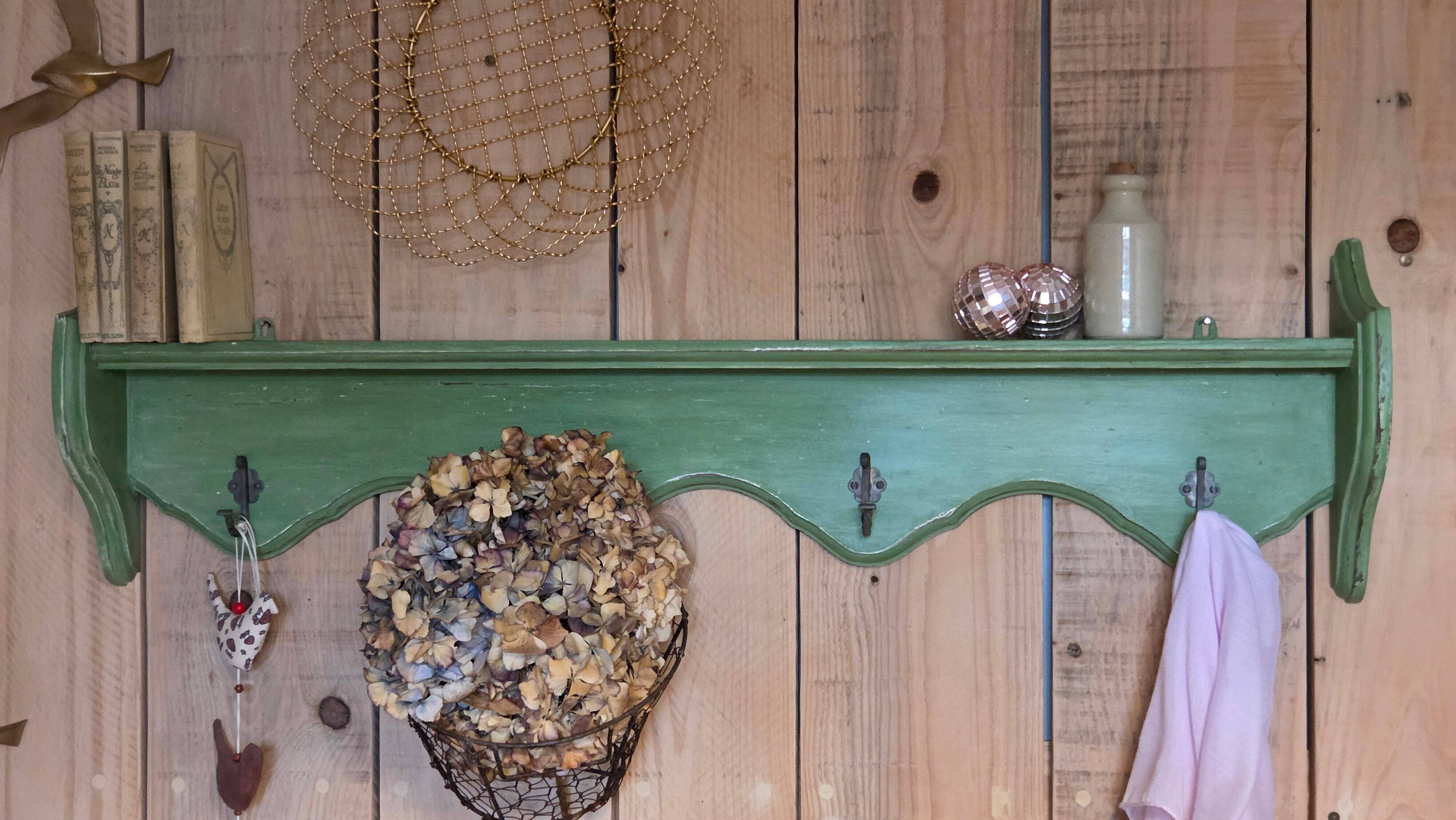 Antique wall shelf with a green patina