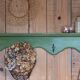Antique wall shelf with a green patina