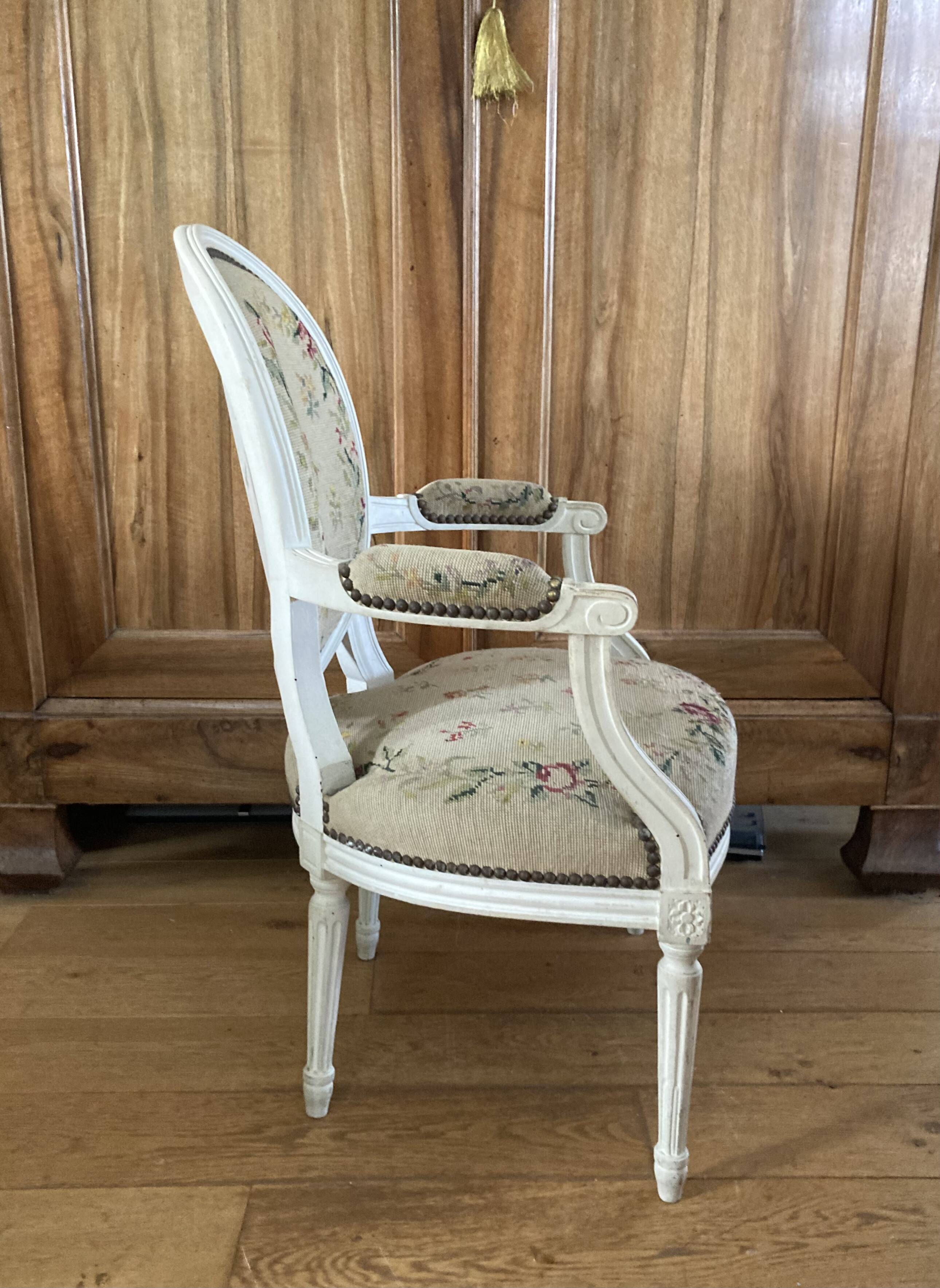 Upholstered armchair with cross-stitch in the Louis XVI style, 19th century.
