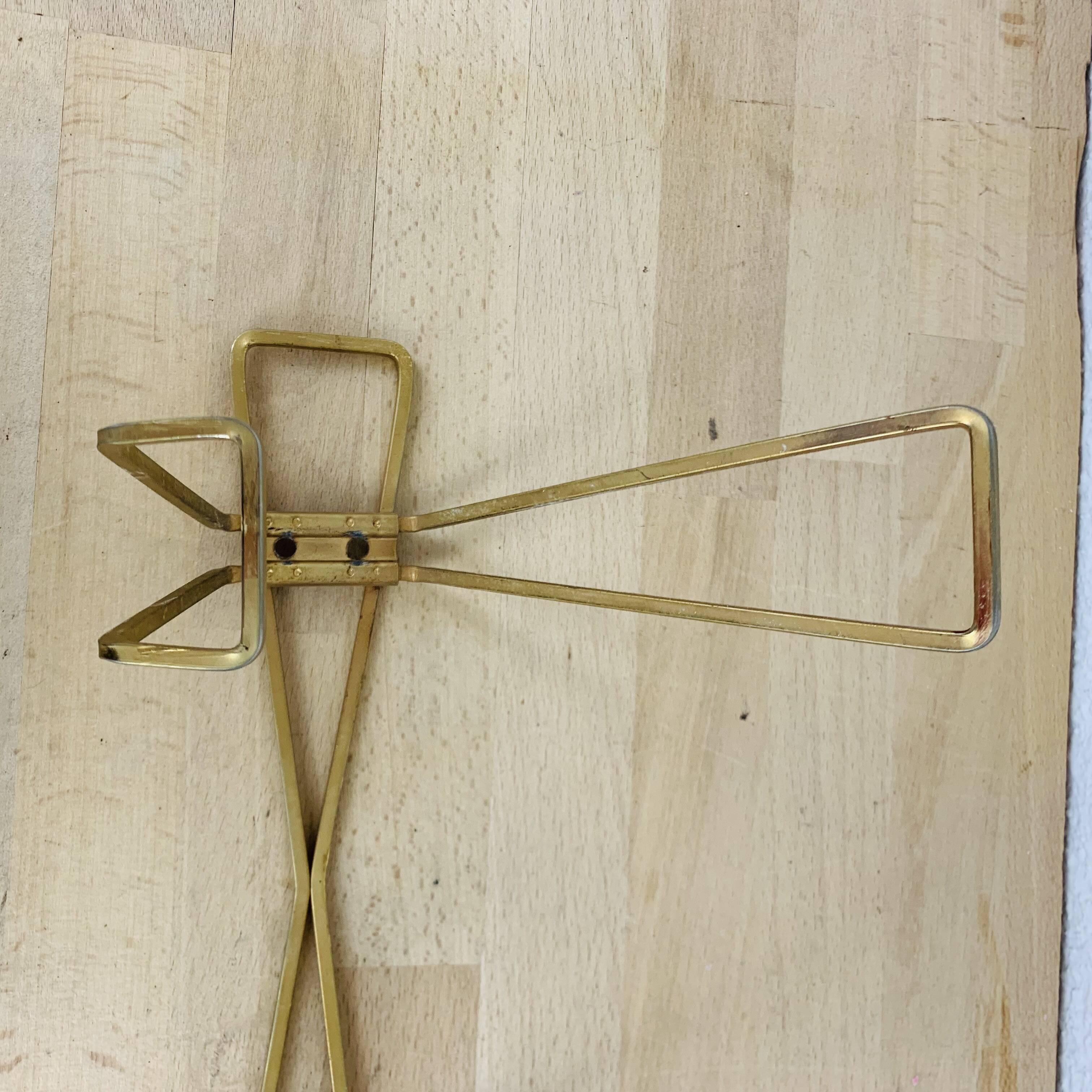 Wall coat rack with golden metal hook from the 1950s