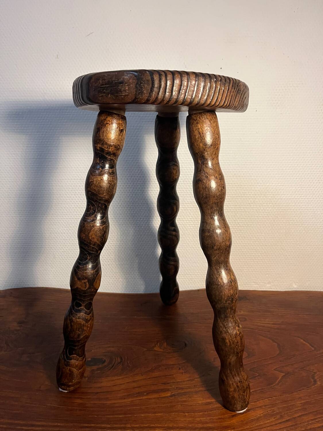 Round wooden tripod stool