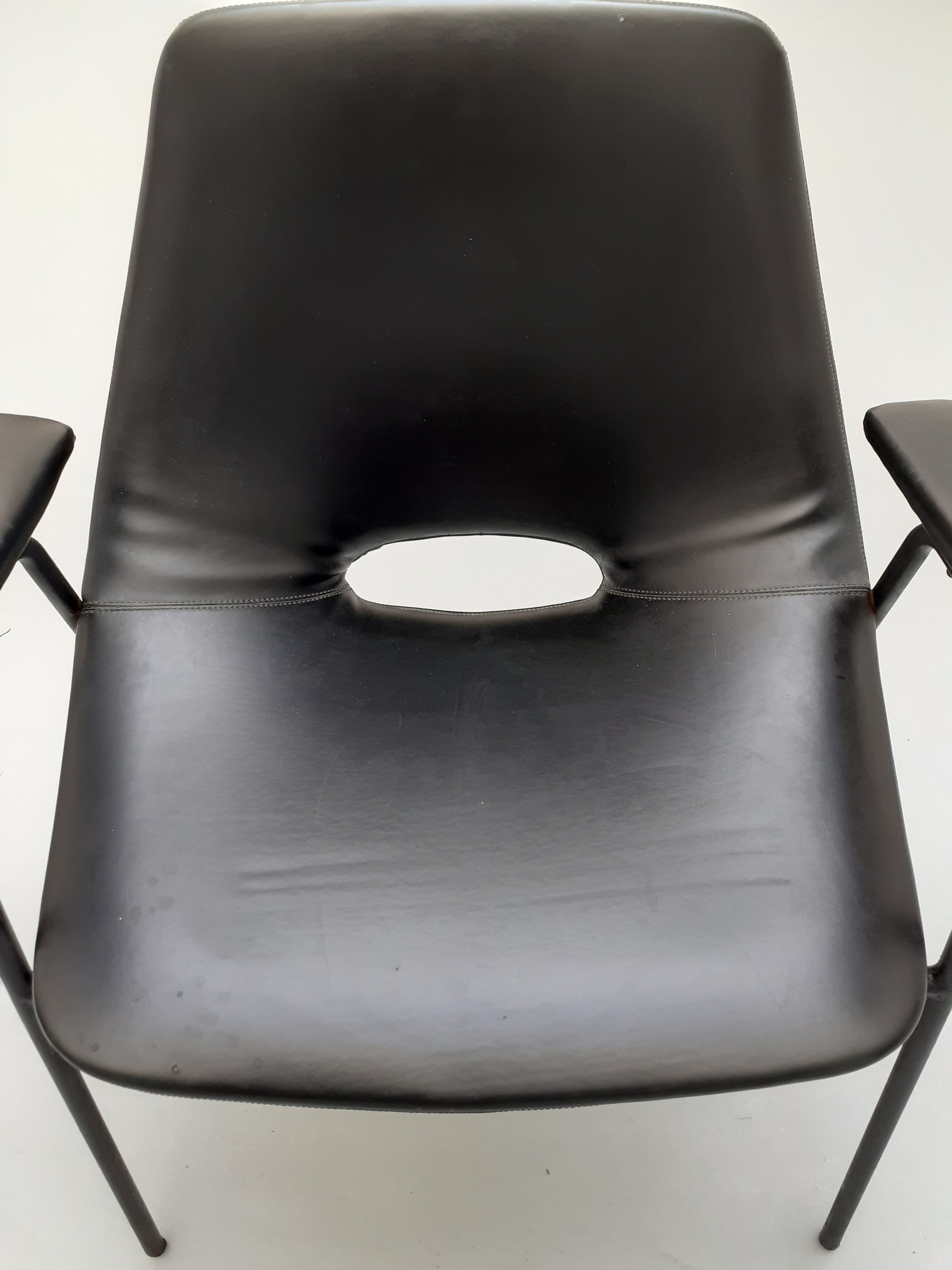 Pair of armchairs, Tonneau model, in black skai by Pierre Guariche, 60s