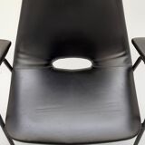 Pair of armchairs, Tonneau model, in black skai by Pierre Guariche, 60s