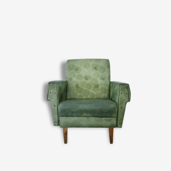 Green armchair in leatherette