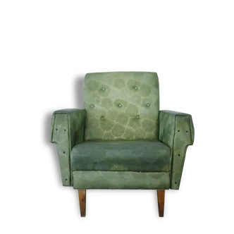 Green armchair in leatherette