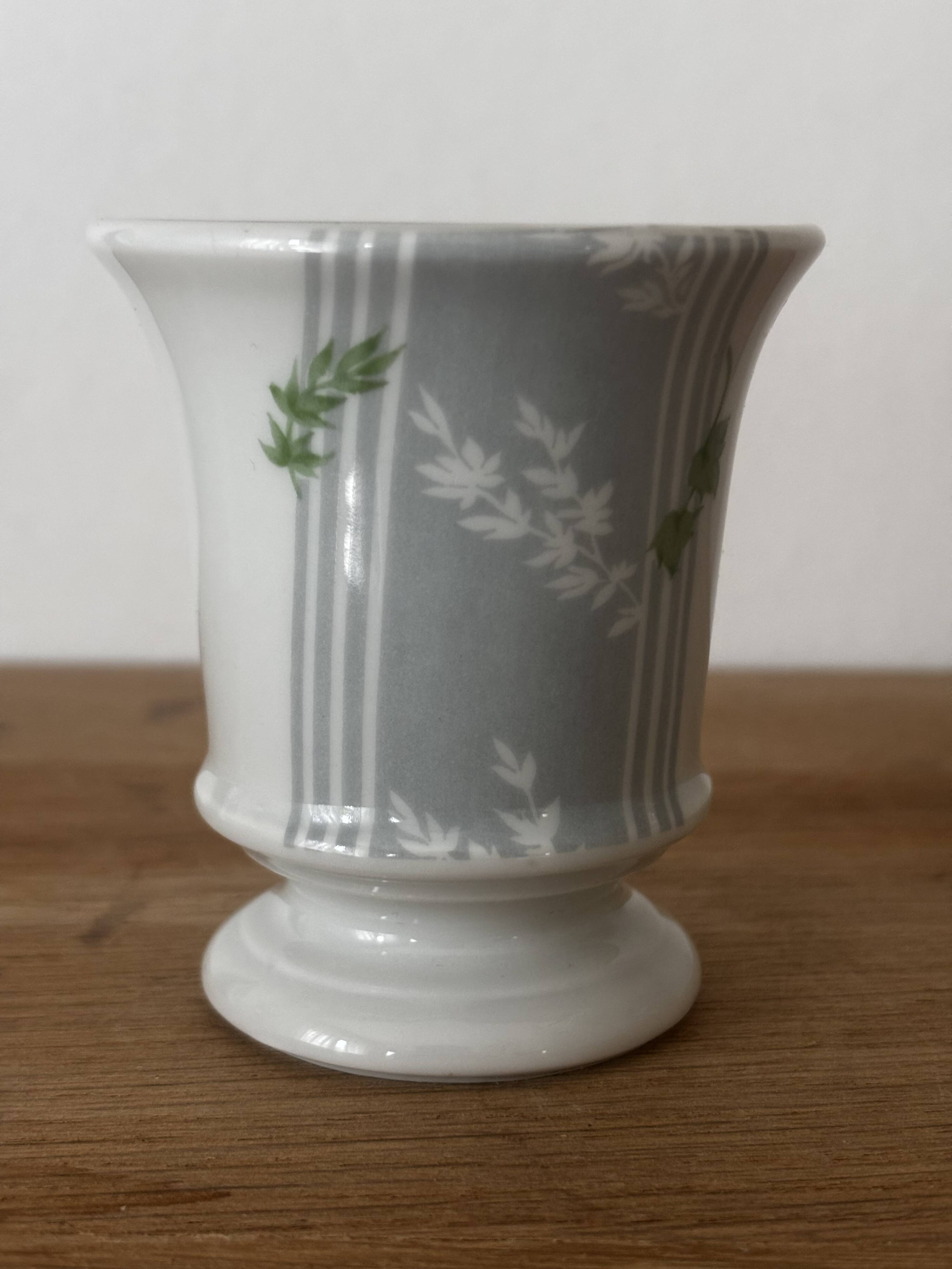 Adorable small porcelain vase from Paris with floral decoration.