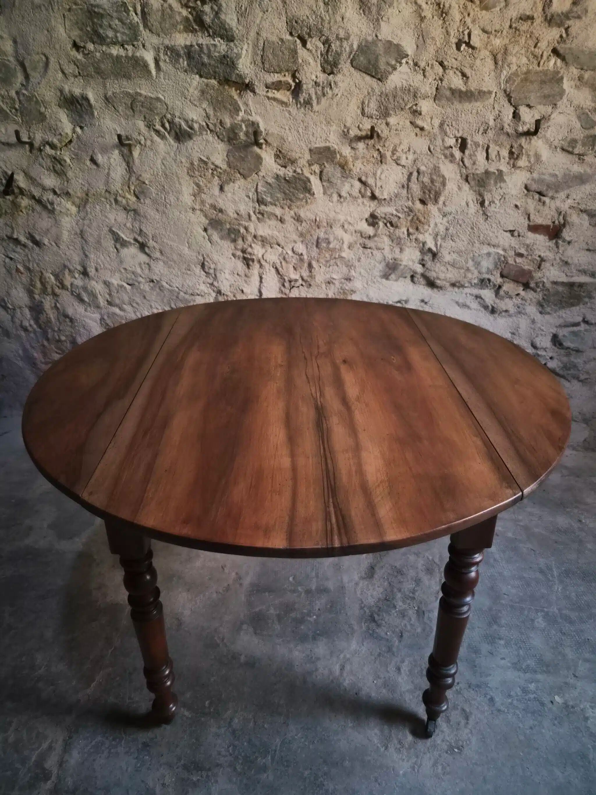 Antique drop-leaf dining table in walnut, France, circa 1900.