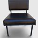 Modernist armchair in black faux leather and metal – 1960s