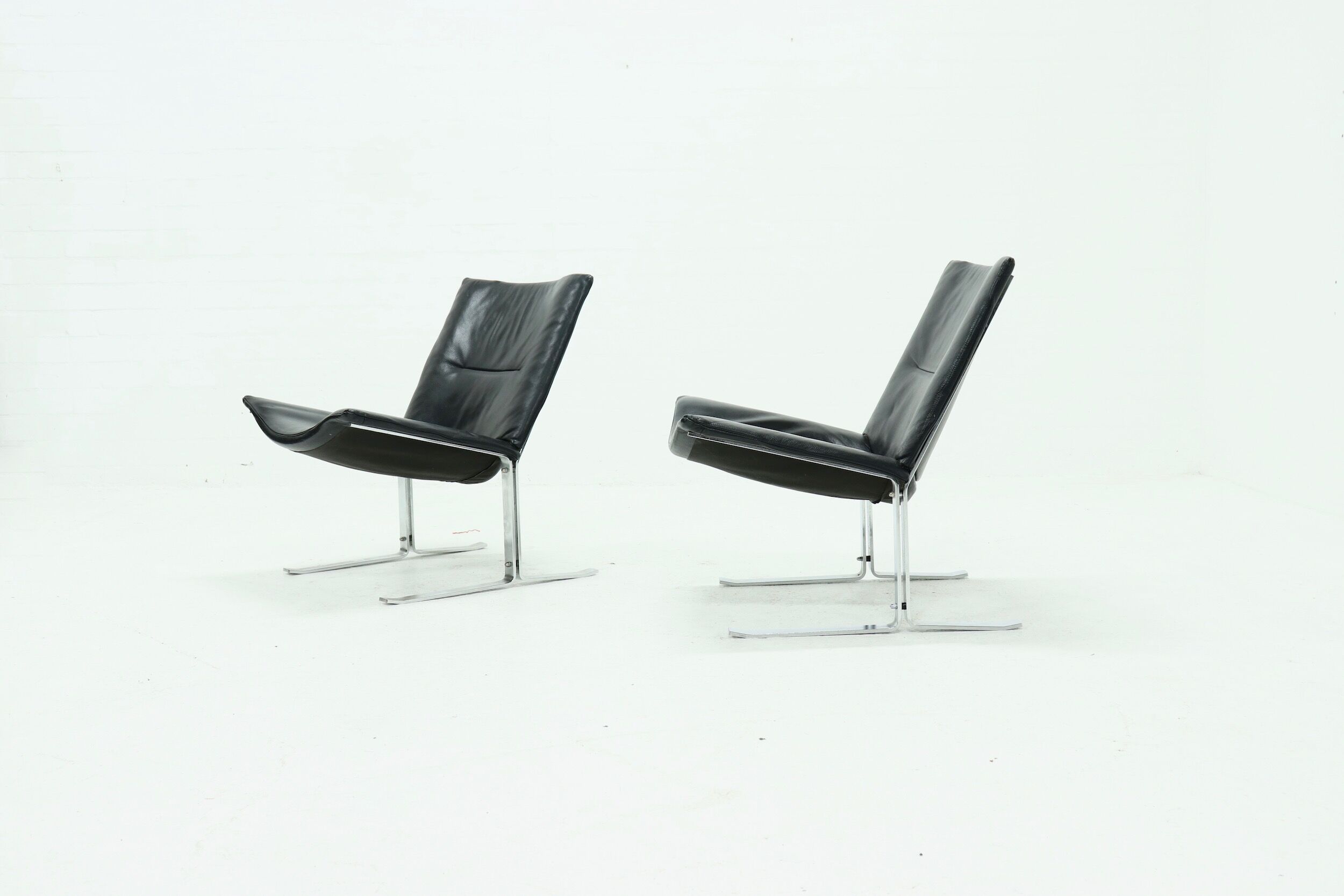 Set of 2 Danish lounge chairs by Kebe Møbler model Eagle with black leather.