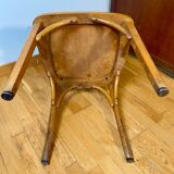 Antique curved wooden armchair in Baumann style