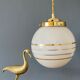 Suspension globe vintage art déco en opaline blanche et dorée