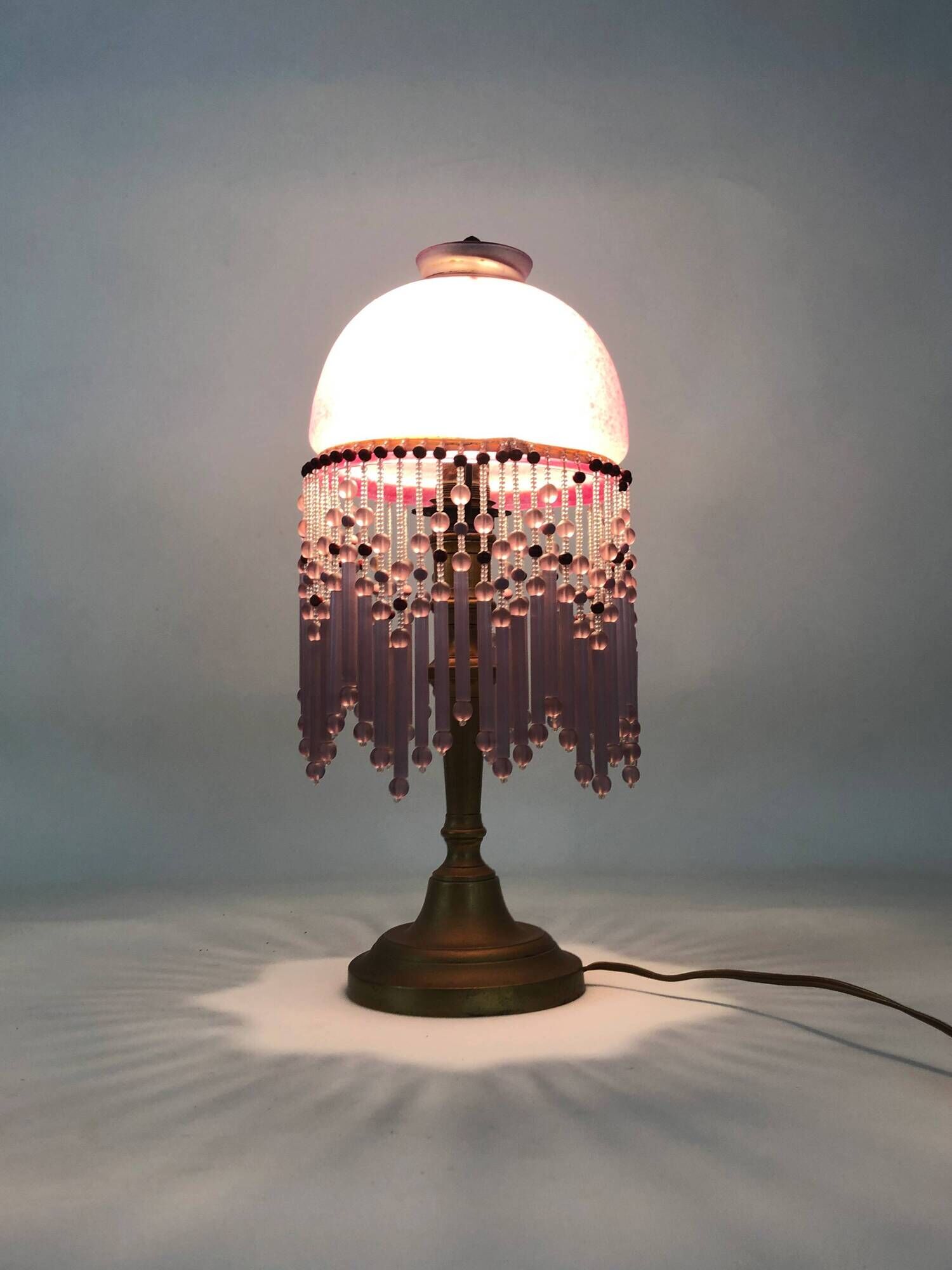 Table lamp, bedside lamp, speckled pink globe and glass and wood beads. Year 60