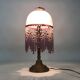 Table lamp, bedside lamp, speckled pink globe and glass and wood beads. Year 60