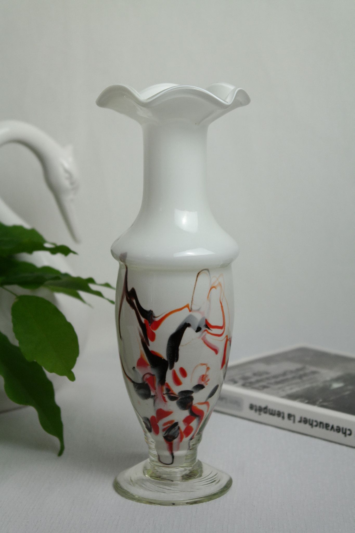 Corolla vase in white opaline with orange-brown patterns.