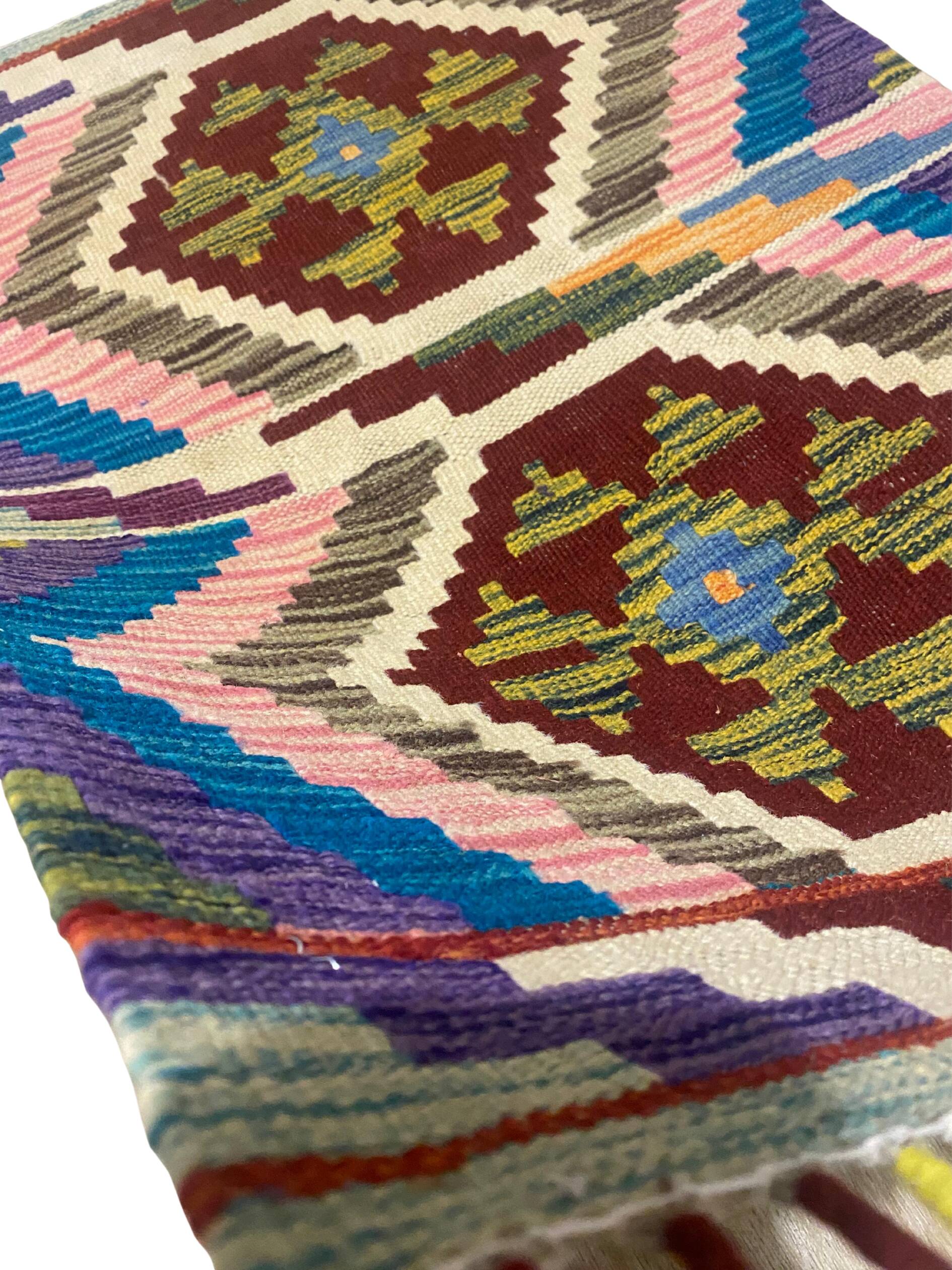 Afghan kilim rug in wool, pastel geometric patterns,