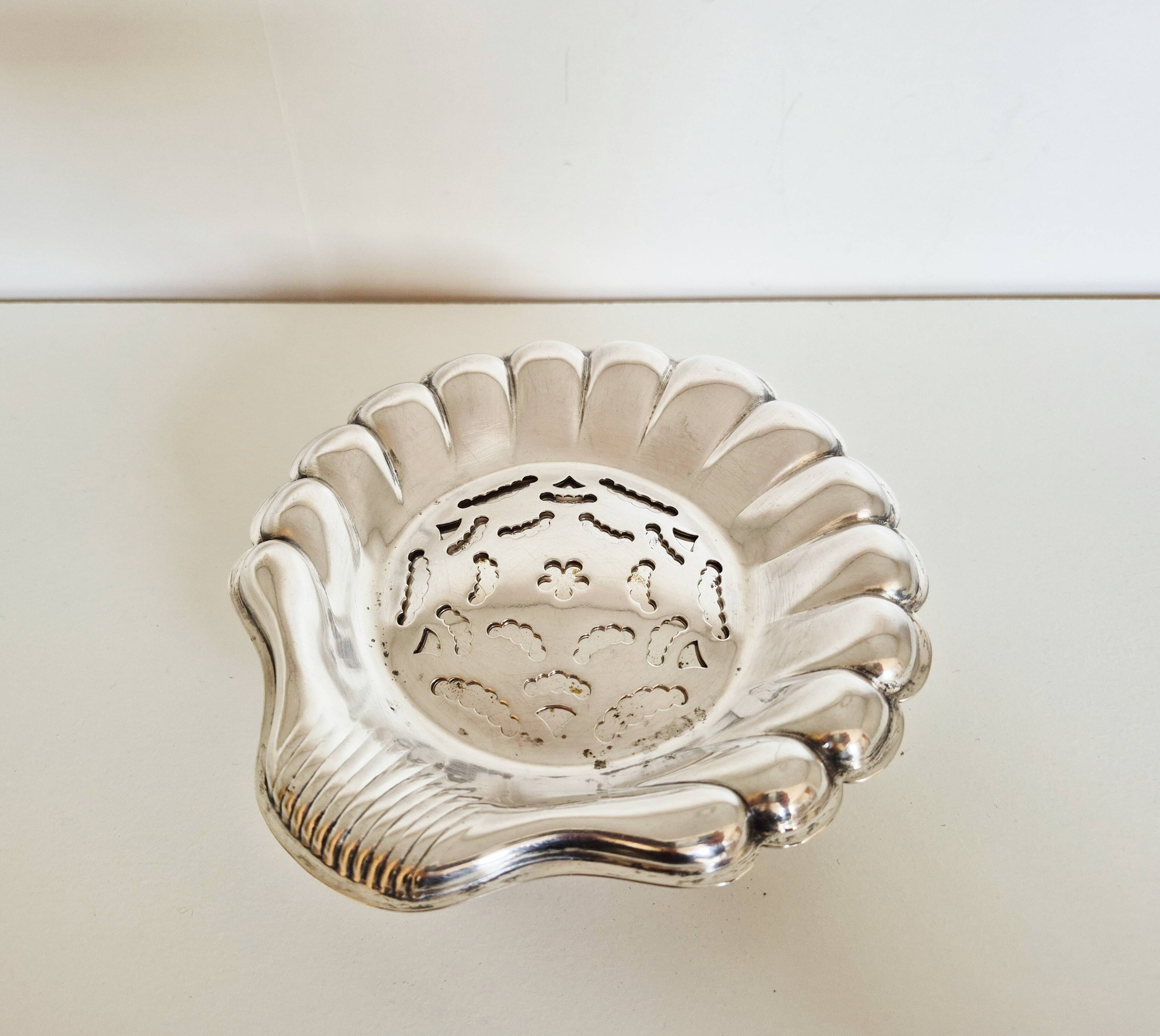 Silver scallop shell butter dish.