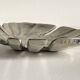 Leaf-shaped metal pocket emptier