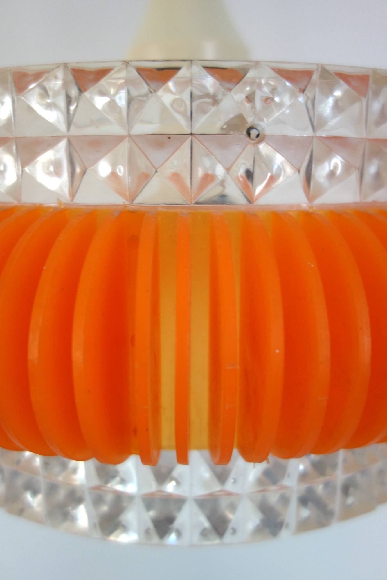 Transparent plastic space age lustre with orange band from the 70s.