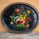 Black lacquered metal tray with multicoloured vintage Russian floral decoration.