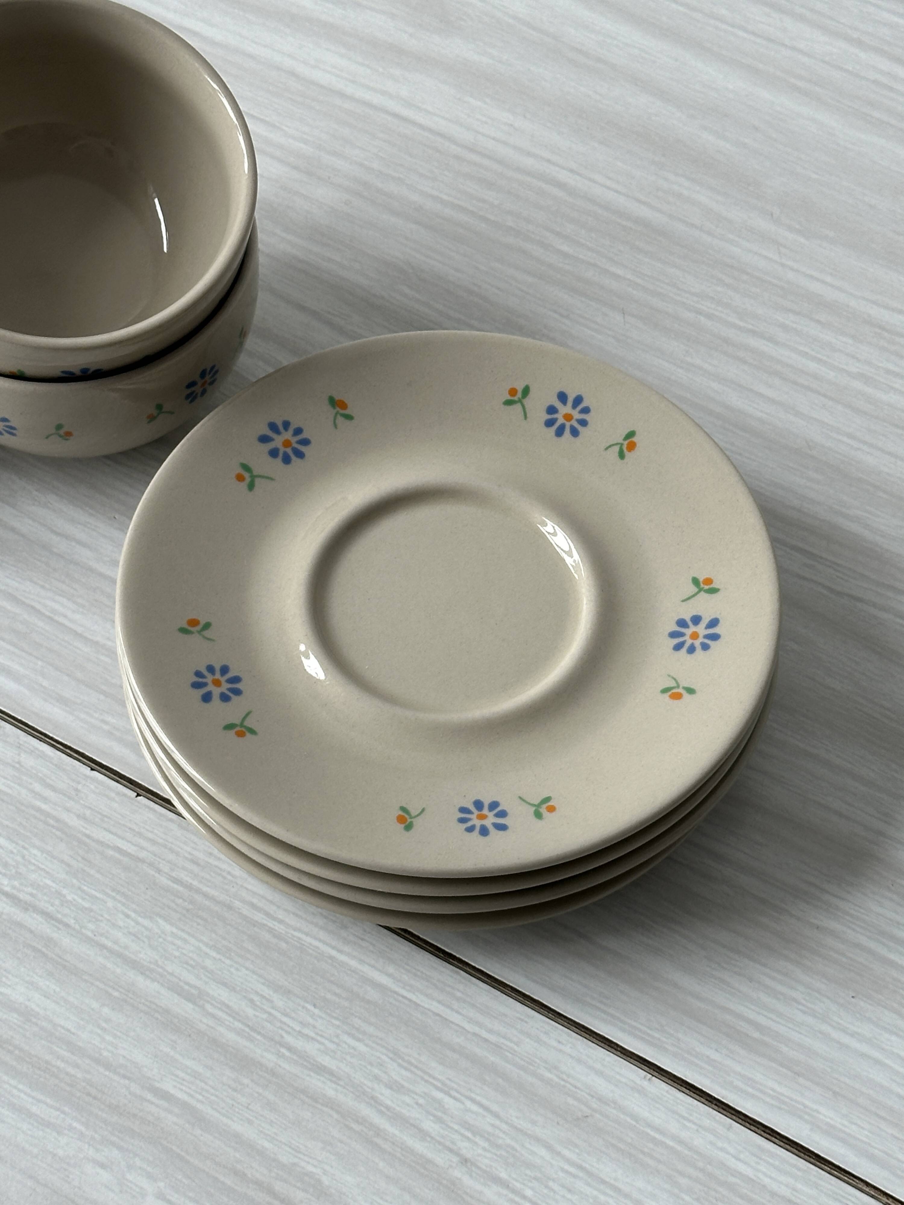 Ceramic cups and saucers with flower decoration