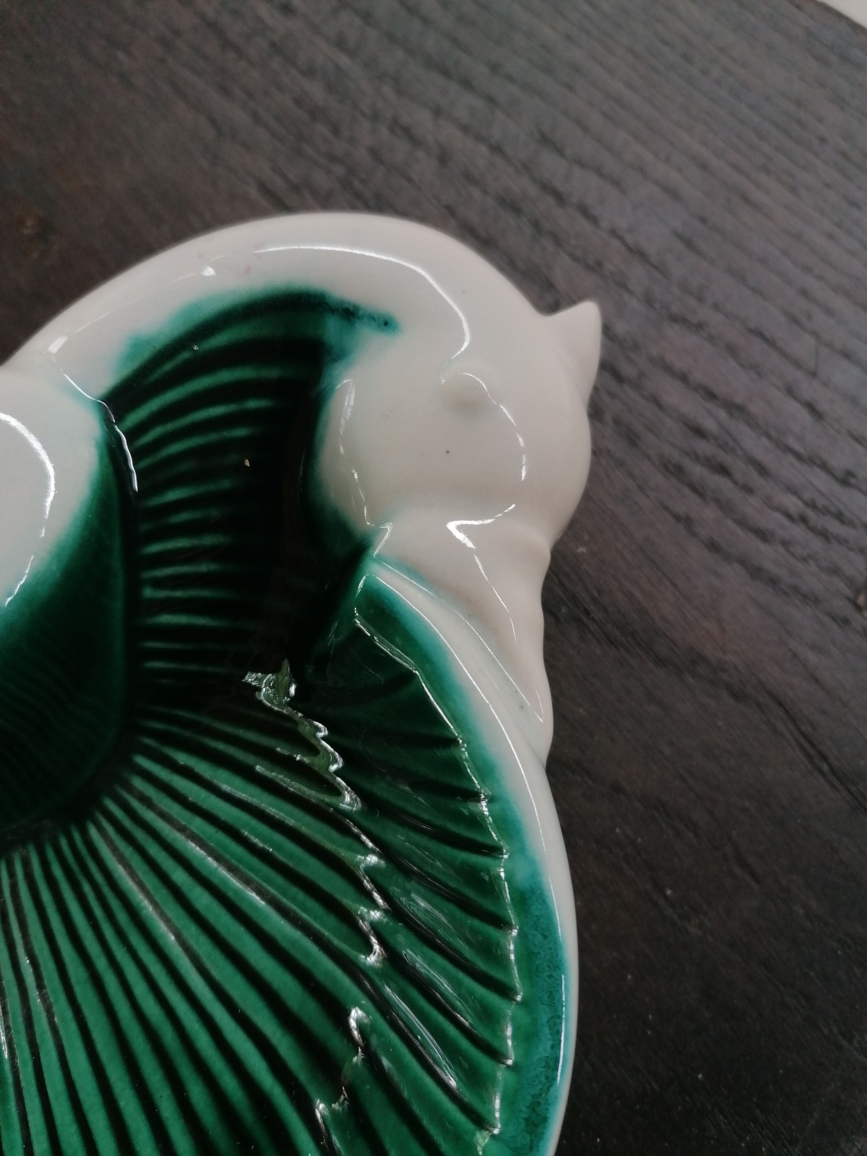 Empty green and white ceramic bird pocket