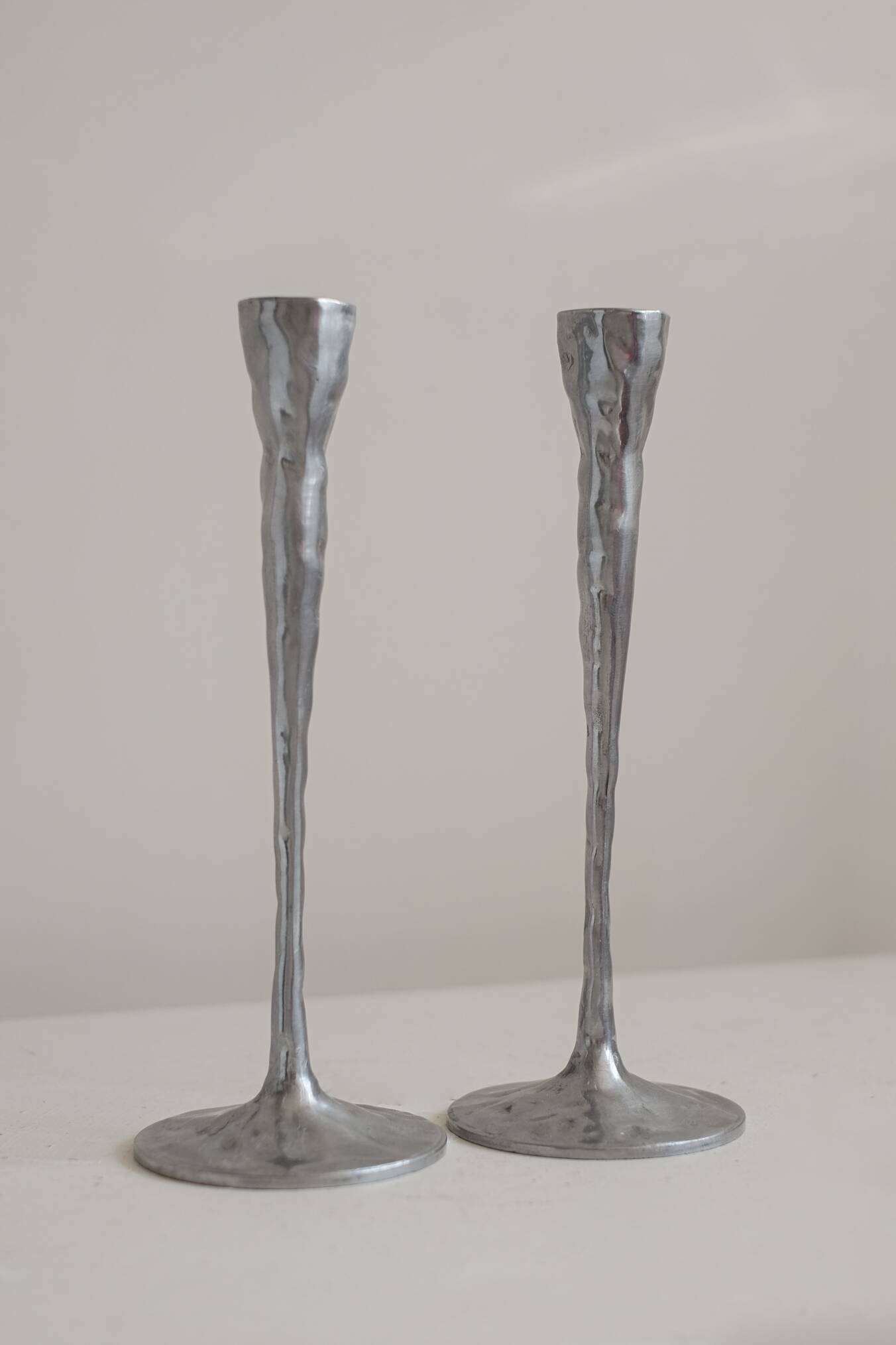 Pair of aluminium candle holders