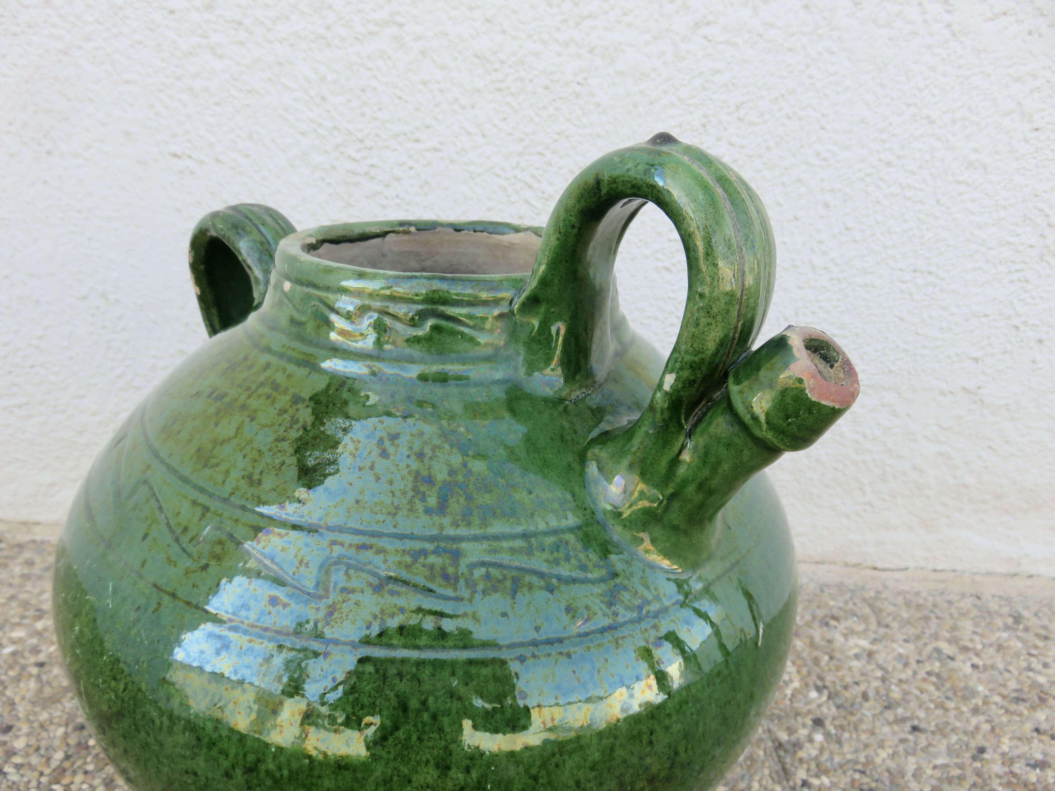 Antique glazed green terracotta oil jar, late 19th century.