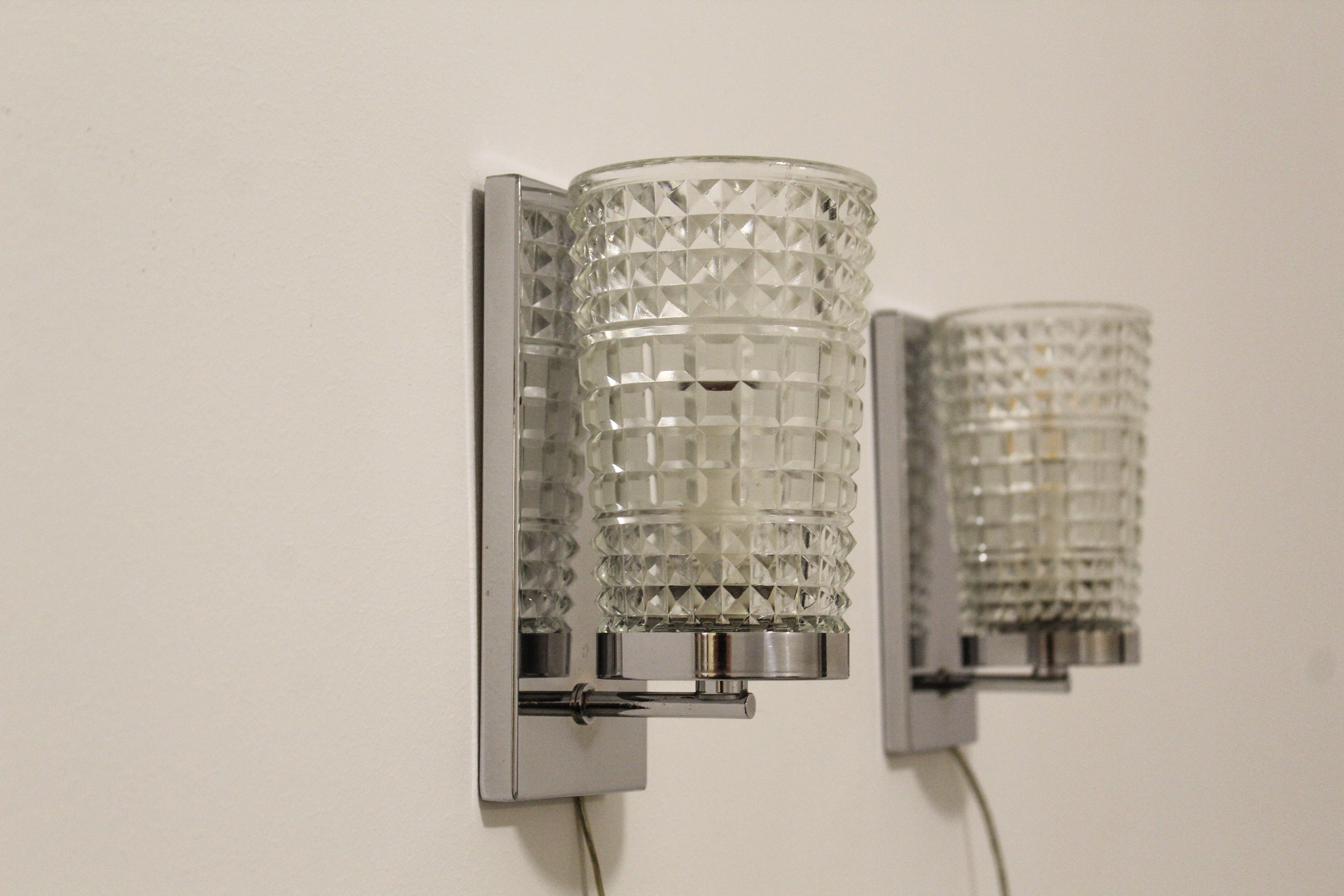 Wall lamps in worked glass and chromed metal, Italy 70's