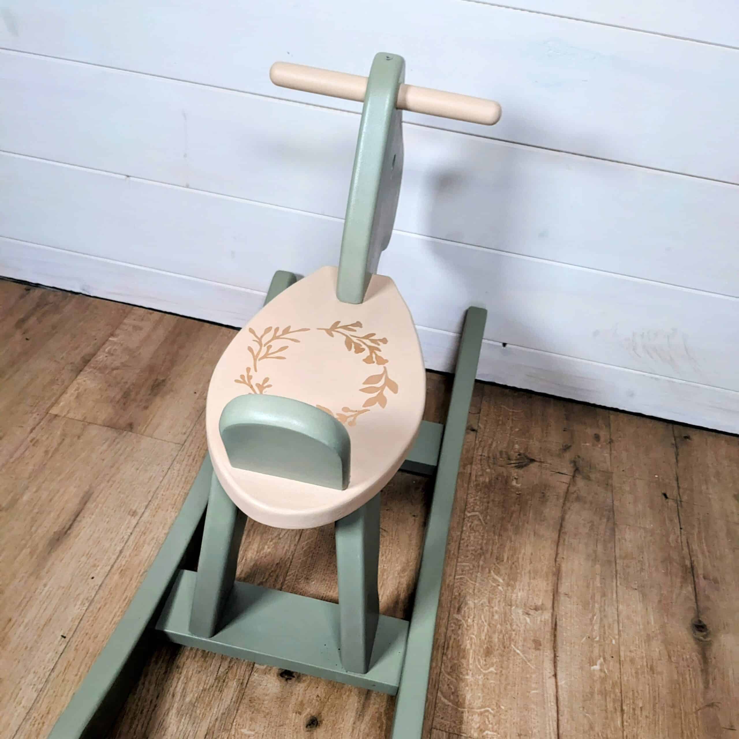 Green and beige wooden rocking horse