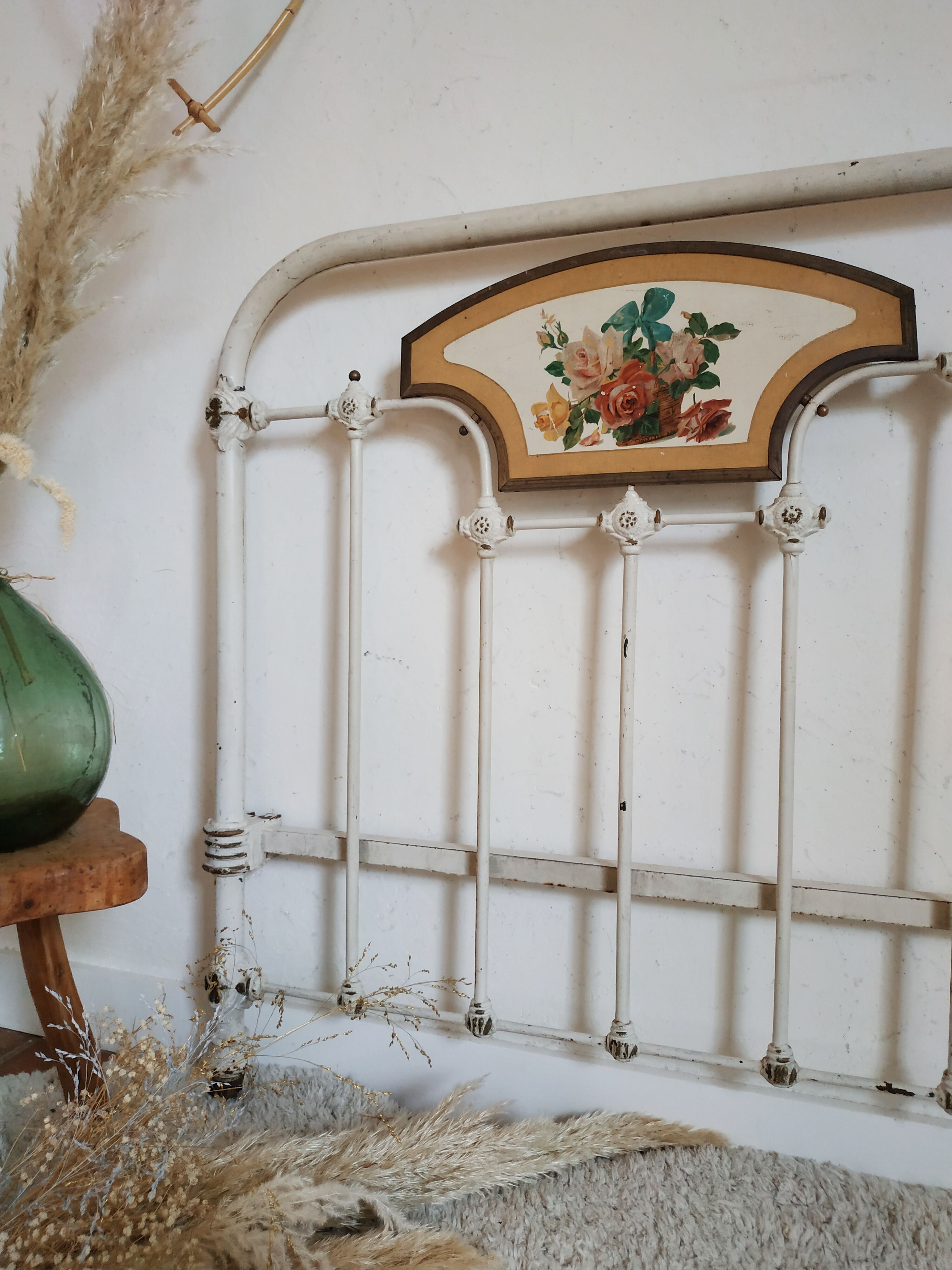Cast-iron headboard and patinated white wood