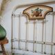 Cast-iron headboard and patinated white wood