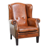 Wingback chair made of sheep leather with black piping in good condition
