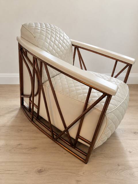 ENNIO armchair in quilted white leather with a copper stainless steel frame.