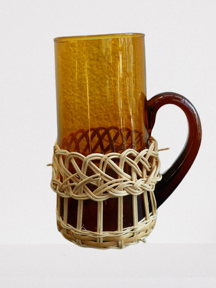 Fruit juice or vintage lemonade service in glass and wicker.