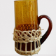 Fruit juice or vintage lemonade service in glass and wicker.